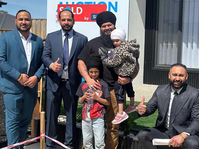 Auction day in Beveridge with bidders and auctioneer